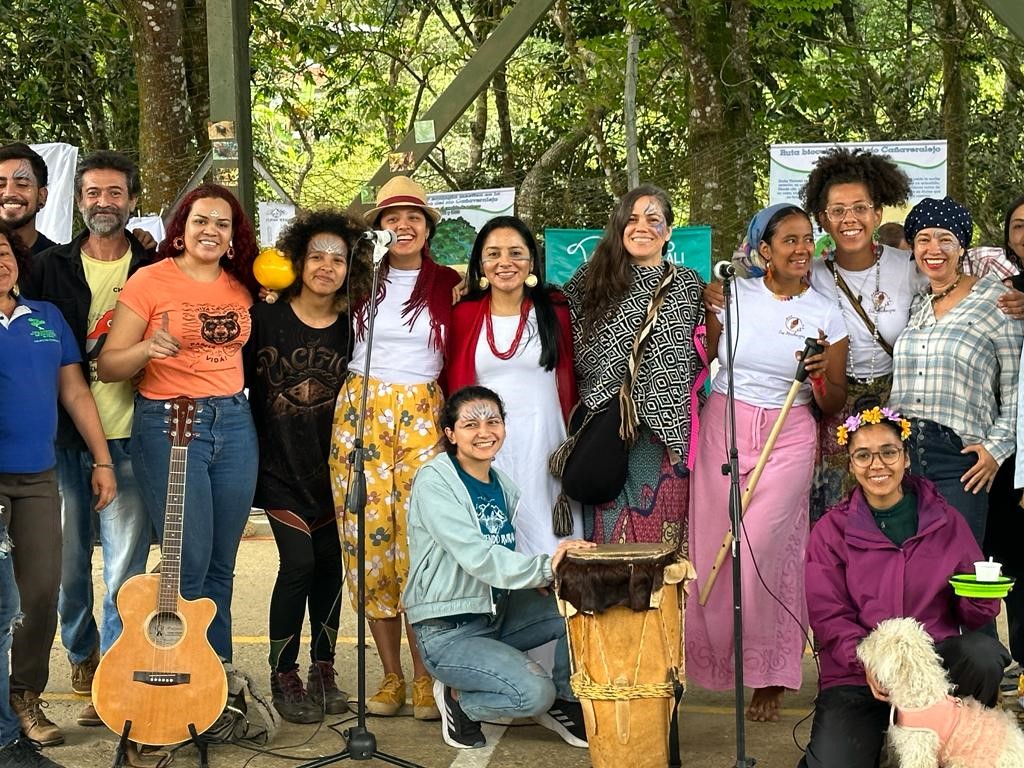Fotografía en la que aparece la concejal Ati acompañada de un grupo de 13 personas e instrumentos musicales 