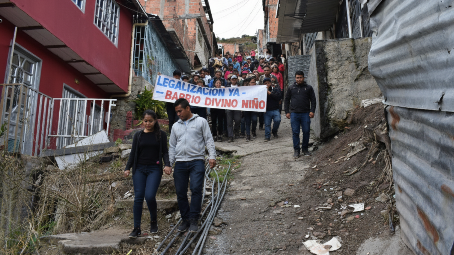 En esta imagen aparecen habitantes del barrio con una pancarta pidiendo la legalización del barrio 