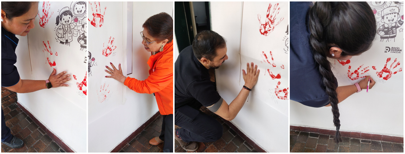 Foto de personas asistentes a la sesión colocando una huella roja